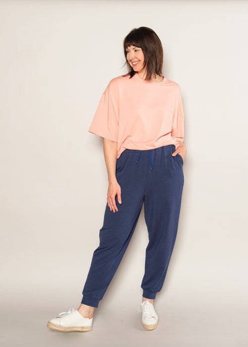 Woman wearing the Maison Top and Joggers sewing pattern from The Sewing Workshop on The Fold Line. A dress pattern made in knit fabrics, featuring a very loose-fitting top with hem band, round bound neckline and full 3/4-length sleeves. Semi-fitted jogger