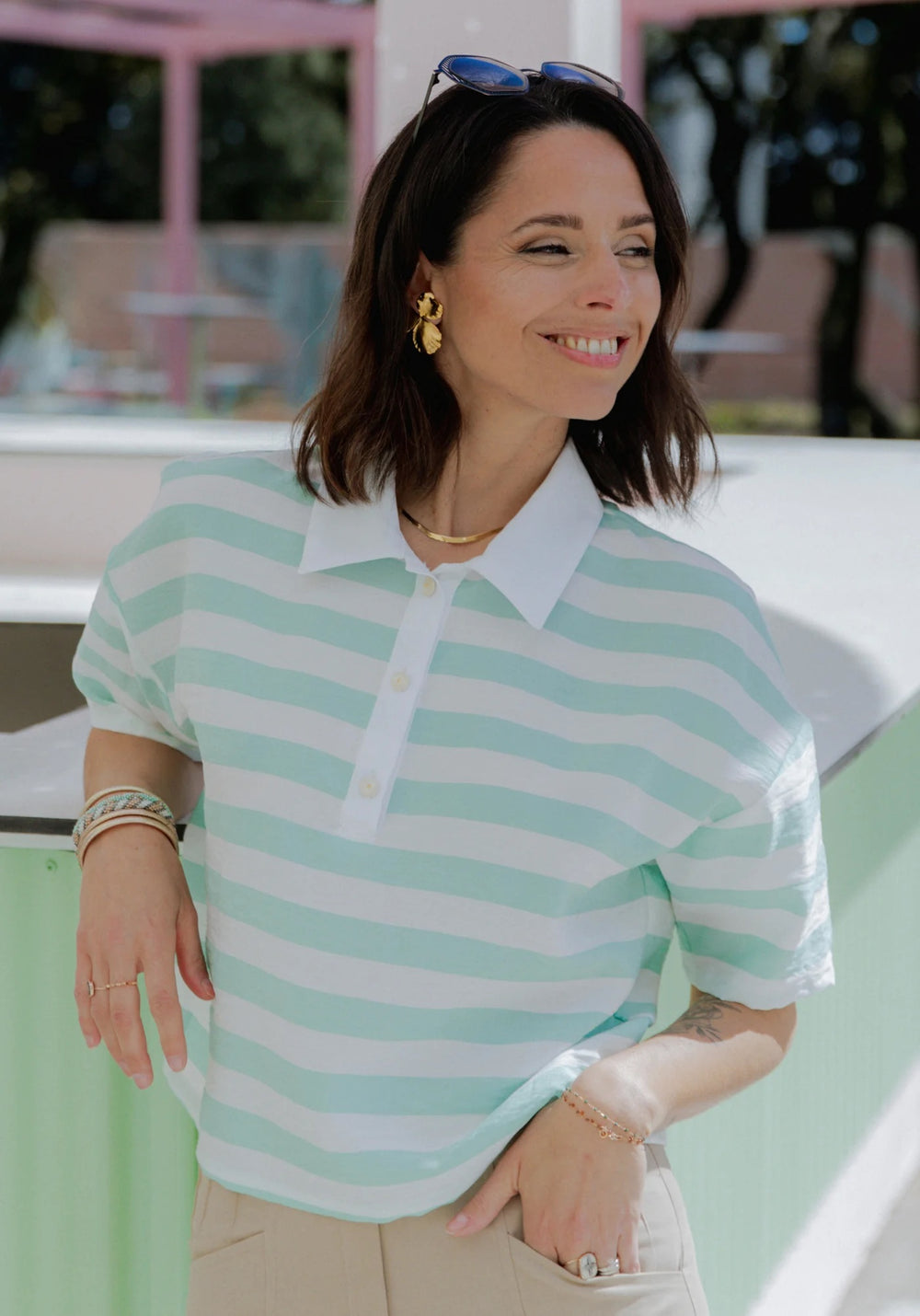 Woman wearing the Malibu Polo sewing pattern from Maison Fauve on The Fold Line. A shirt pattern made in lightweight woven fabric, featuring a slightly loose, cropped straight cut, dropped shoulders, collar, button placket, and elbow length sleeves.