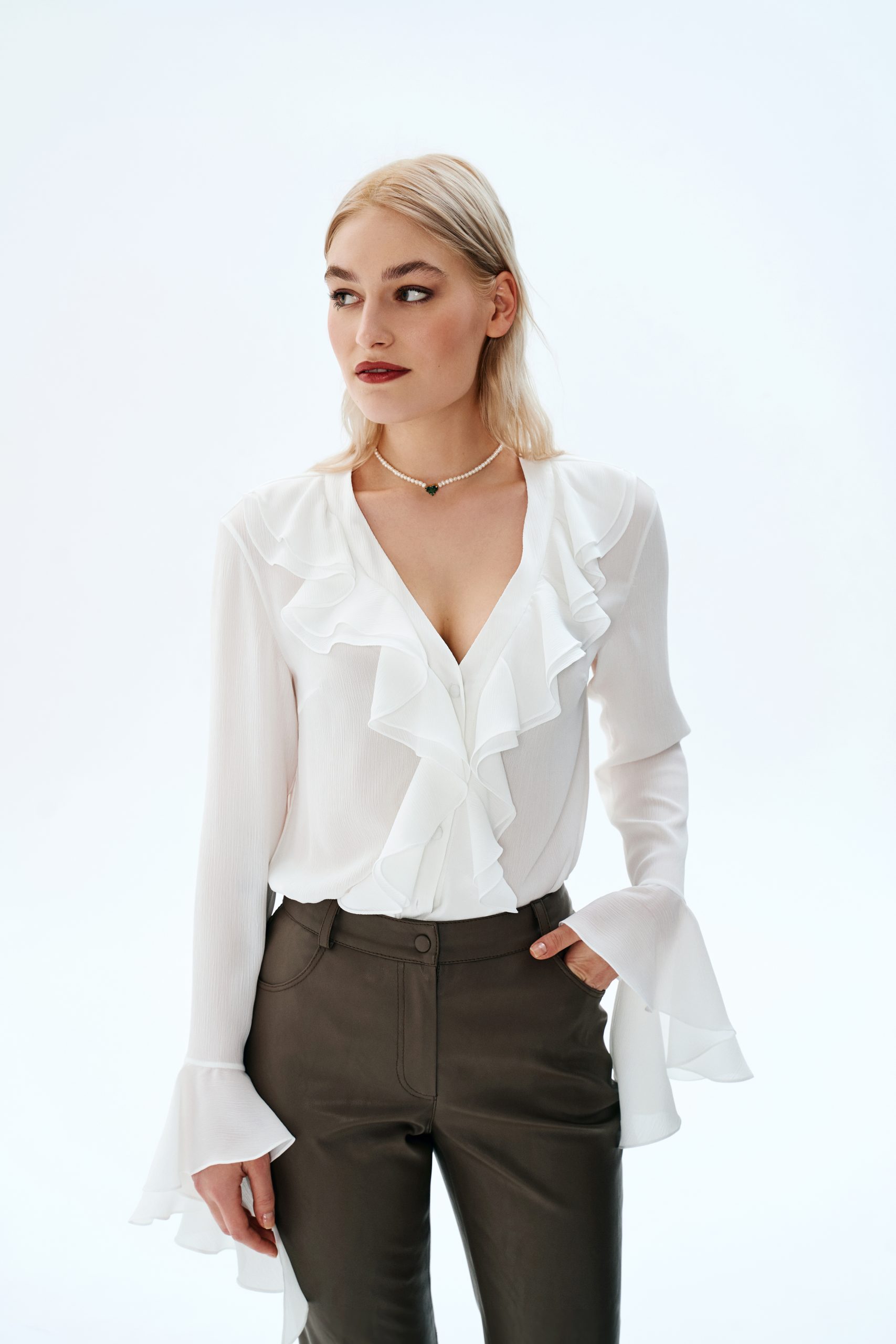 Woman wearing the Mallory Blouse sewing pattern from Vikisews on The Fold Line. An blouse pattern made in satin, dress-weight viscose, chiffon, crepe de chine, natural or synthetic lightweight silk fabrics, featuring a semi-fit with straight cut, front bu