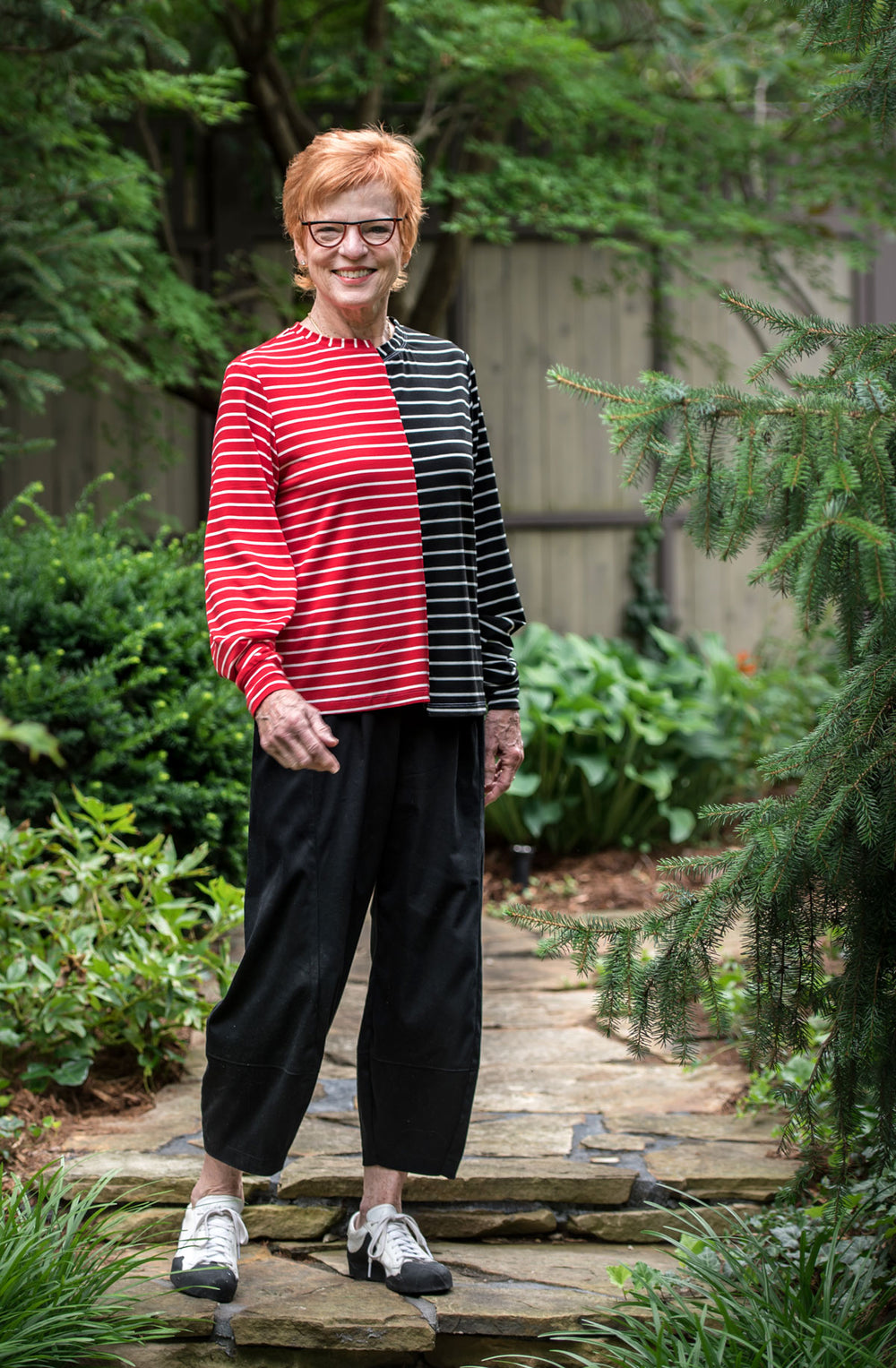 Woman wearing the Marceau Tee sewing pattern from The Sewing Workshop on The Fold Line. A T-shirt pattern made in light to medium weight knit fabrics, featuring a loose-fit, hip-length, shifted right and left sides, two-piece sleeves with cuffs and pleate