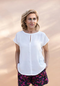 Woman wearing the Marisa Top sewing pattern from Maison Fauve on The Fold Line. A top pattern made in poplin, crepe, twill, viscose, cotton, silk, linen, lace or broderie anglaise fabrics, featuring a relaxed fit, round neckline with slit in the centre fr