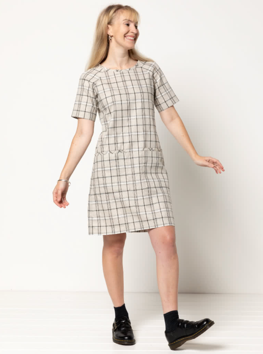 Woman wearing the Mary Shift Dress sewing pattern from Style Arc on The Fold Line. A shift dress pattern made in linen or cotton fabrics, featuring a round neck, short raglan sleeves, shoulder darts, two front patch pockets and knee length.