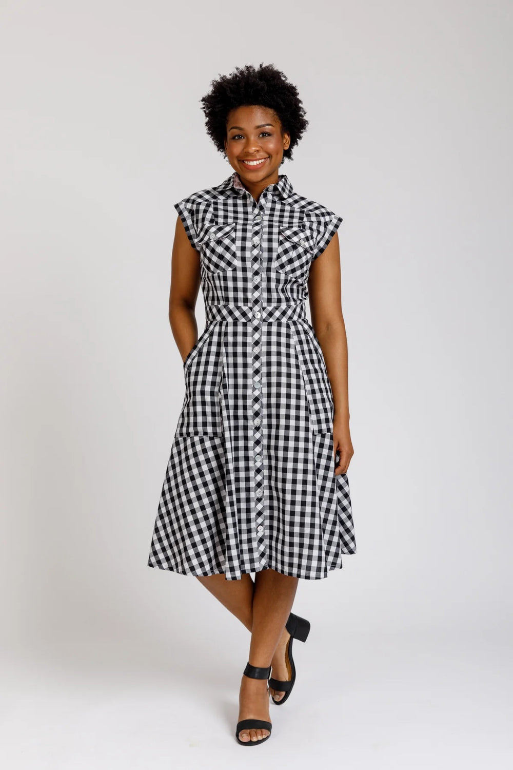 Woman wearing the Matilda Dress sewing pattern from Megan Nielsen on The Fold Line. A shirt dress pattern made in cotton, linen, chambray, rayon, tencel, or silk fabrics, featuring princess seams, drop shoulder, sleeveless, front button closure, back yoke
