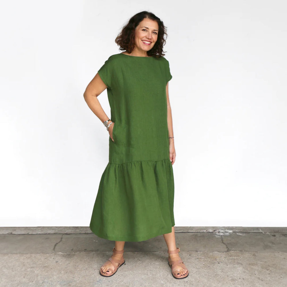 Woman wearing the Mattea Dress sewing pattern from Tessuti Fabrics on The Fold Line. A dress pattern made in linen, cotton, viscose or silk fabrics, featuring a semi-fitted bodice, boat neckline, dropped shoulders, sleeveless, calf-length, dropped waist, 