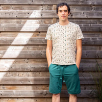 Man wearing the Unisex Matty T-shirt sewing pattern from WISJ Designs on The Fold Line. A T-shirt pattern made in stretch fabrics, featuring short sleeves, round neck and chest patch pocket.