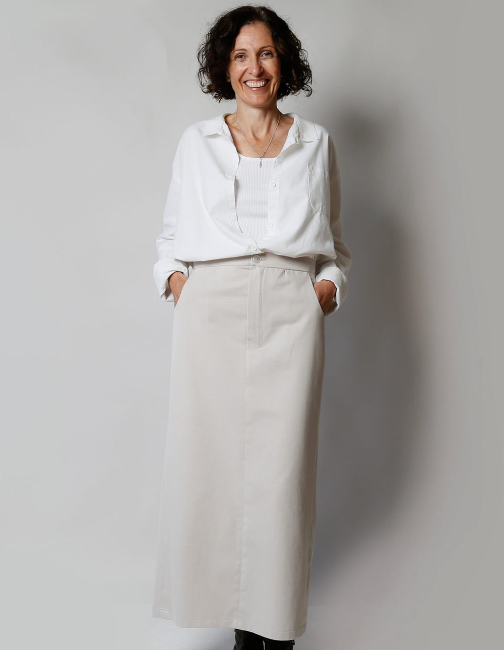 Woman wearing the Maxi Skirt sewing pattern from The Maker’s Atelier on The Fold Line. A skirt pattern made in cottons, linens, denim, or wool suiting fabrics, featuring a maxi length, fly front fastening, front slash pockets, back patch pockets, and high