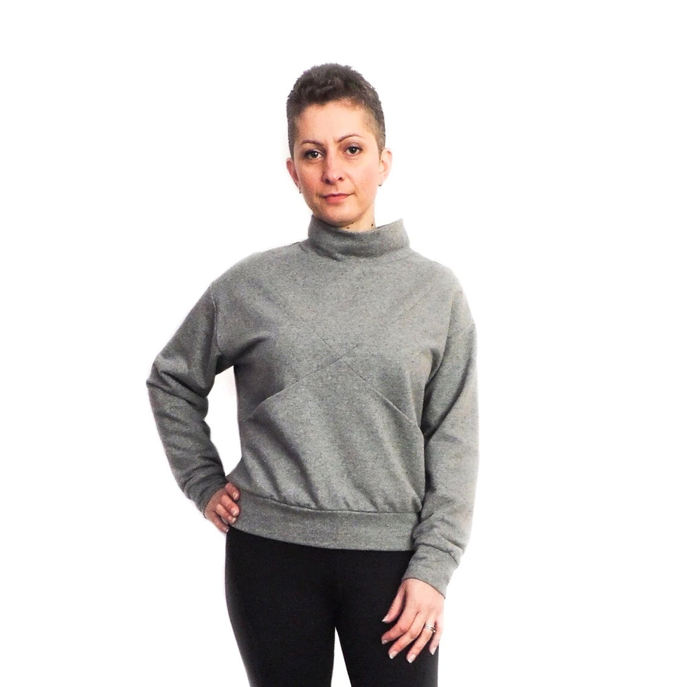 Women wearing the Maxine Sweater sewing pattern from Dhurata Davies Patterns on The Fold Line. A sweater pattern made in medium to heavy weight stretch fabrics, featuring a criss-cross front detail, front pockets, turtle neck, drop shoulder, ribbed waistb