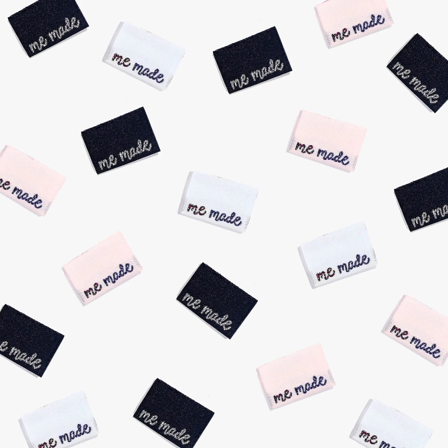 Photo showing 'Me Made’ Labels from Kylie & The Machine on The Fold Line. A washable, durable, and non-scratchy label. Included are 6 double-sided woven labels, 2 x pale blue background with silver and mauve glitter text, 2 x pale pink background with sil