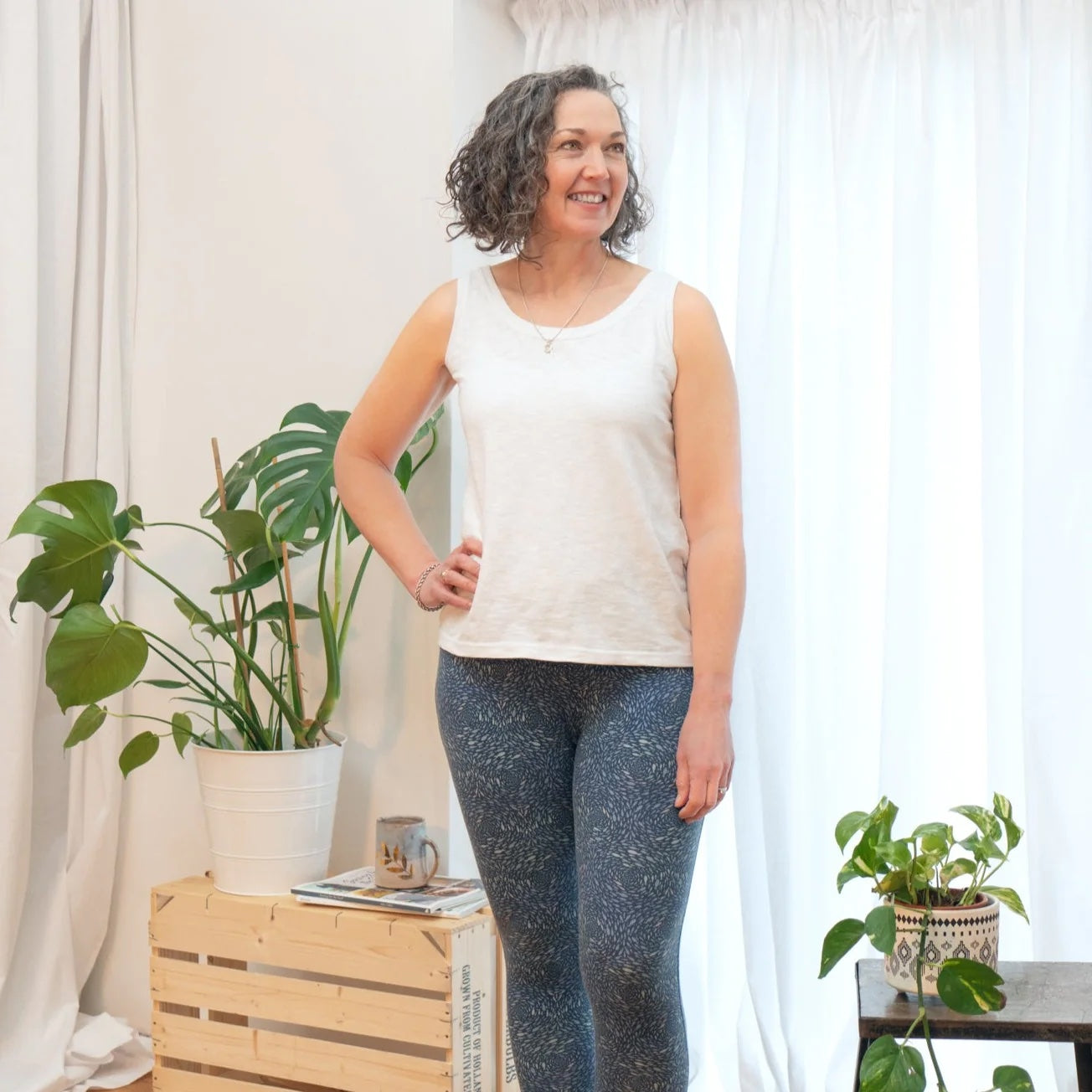 Woman wearing the Mechanicals Loungewear Set 1 sewing pattern from Sew Me Something on The Fold Line. A knit top and leggings pattern made in single or double jersey fabrics, featuring a vest top with scoop neck, hip level length and broad shoulder straps