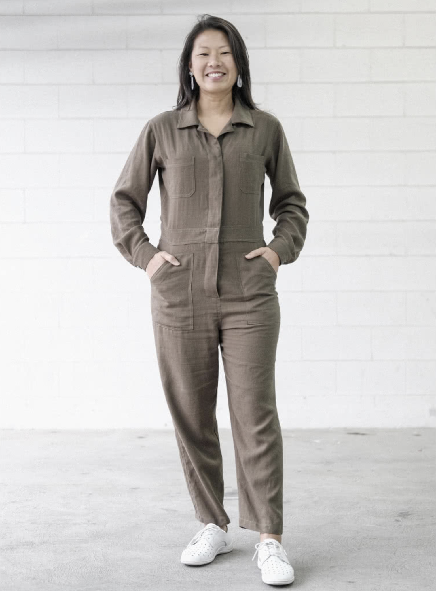 Woman wearing the Melrose Boiler Suit sewing pattern from Style Arc on The Fold Line. A boilersuit pattern made in drill, washed linen, denim or crepe fabrics, featuring a button front, long sleeves with button cuffs, doubled back yoke, shirt collar with 