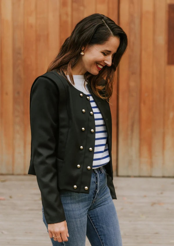 Woman wearing the Metropolis Jacket sewing pattern from Maison Fauve on The Fold Line. A jacket pattern made in jacquard, gabardine, denim, velvet, or fine wool fabrics, featuring a double row of buttons down the front, pockets, shoulder bands, full lengt