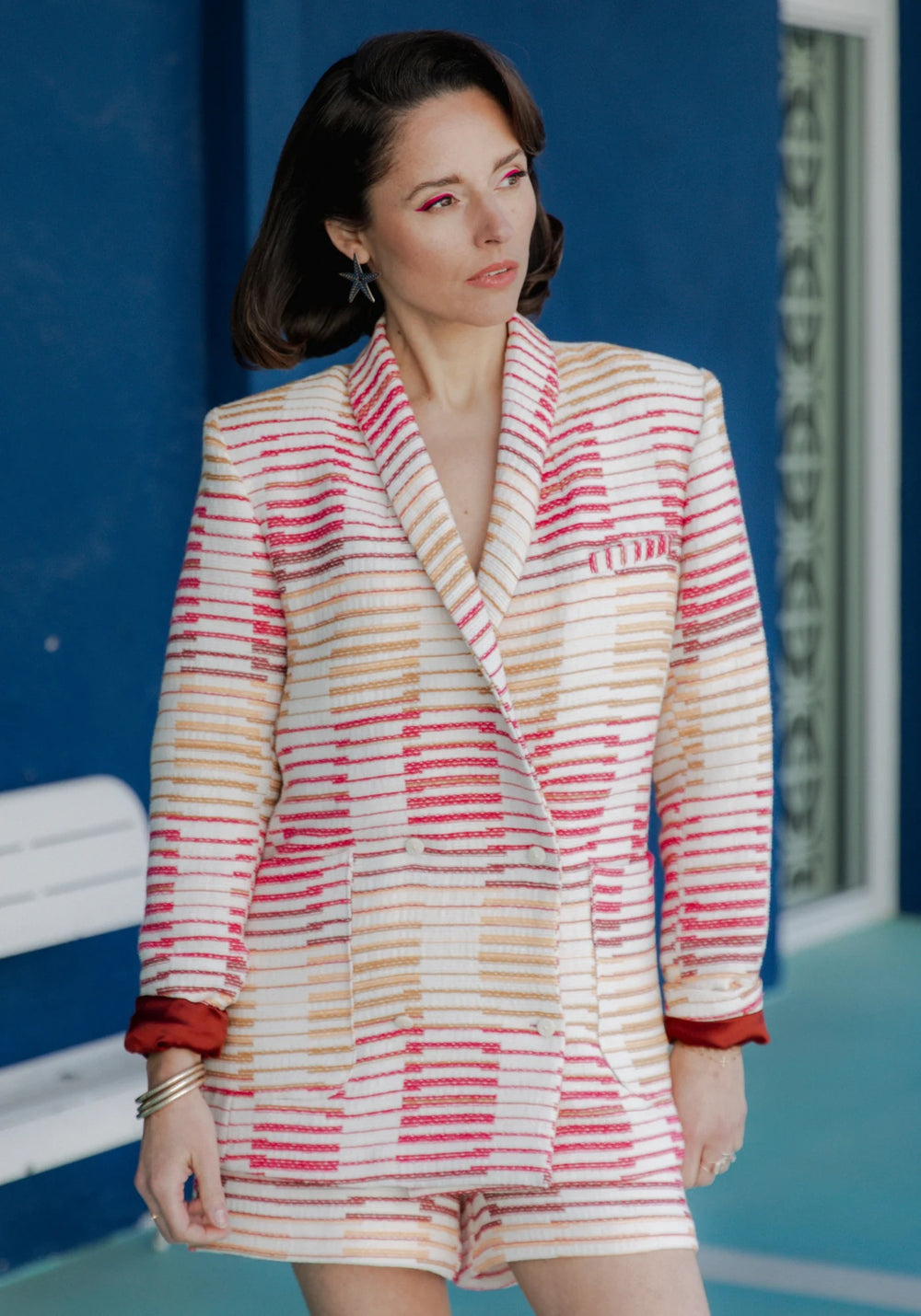 Woman wearing the Mimosa Blazer sewing pattern from Maison Fauve on The Fold Line. A blazer pattern made in wool, tweed, jacquard, gabardine, or denim fabric, featuring a straight cut, shawl collar, two-piece sleeves, side panels, a false welt chest pocke