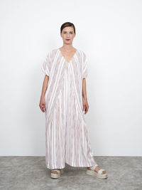 Woman wearing the Minimalist Kaftan Dress sewing pattern from The Assembly Line on The Fold Line. A dress pattern made in light to medium light weight fabrics such as viscose, featuring a relaxed silhouette, V-neck at front and back, box pleat in the back