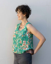 Woman wearing the Miri Tank Top sewing pattern from Sew DIY on The Fold Line. A sleeveless top pattern made in linen, chambray, cotton lawn, poplin, double gauze, rayon, Tencel or crepe de chine fabrics featuring an A-line shape, fitted bust with cup size