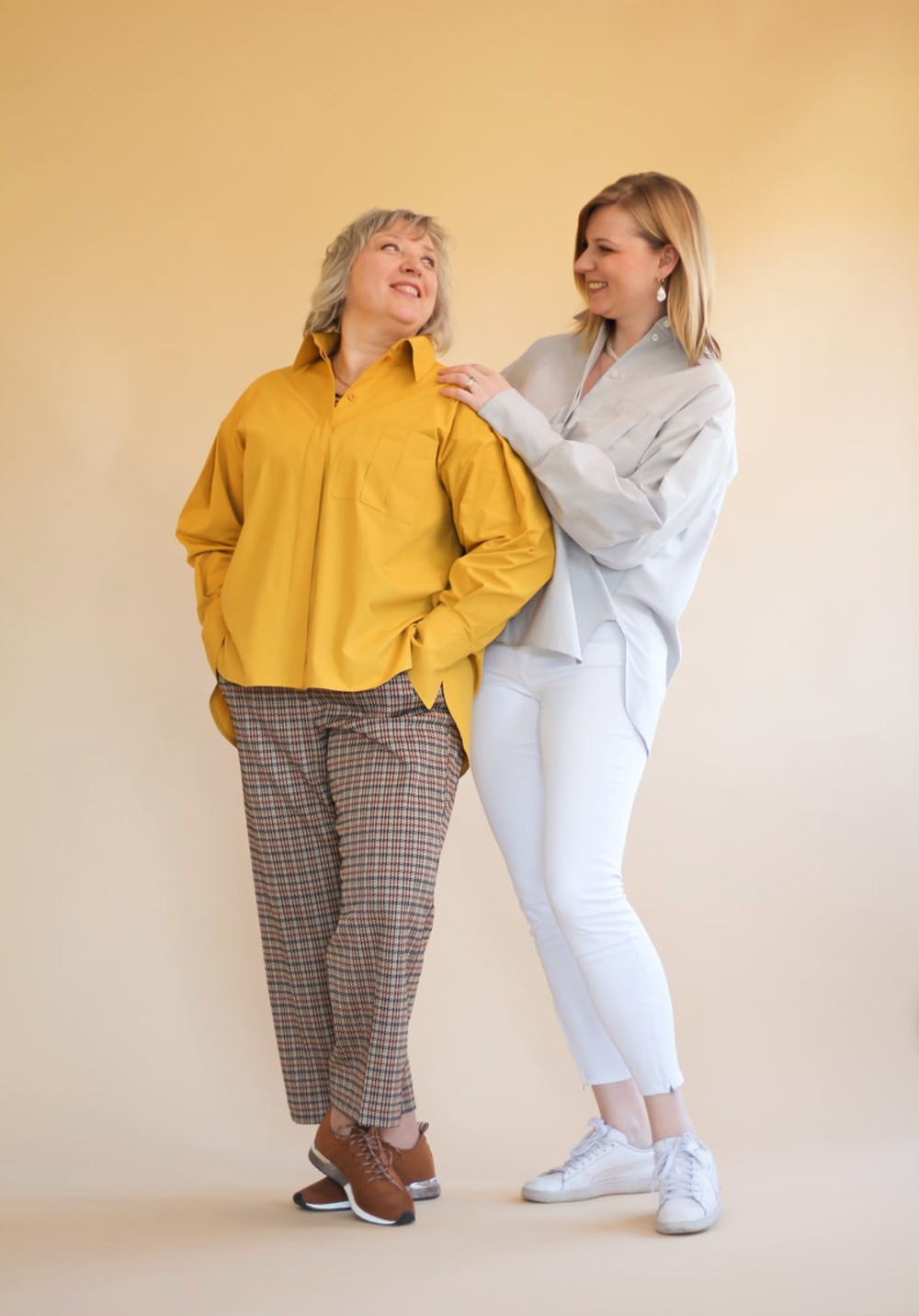 Women wearing the Misha Shirt sewing pattern by Lenaline Patterns. An oversized shirt pattern made in cotton’s, linen, tencel, chino or flannel fabrics, featuring long sleeves, with pleats at the top and bottom, ending in wide cuffs, shirt collar, hidden 