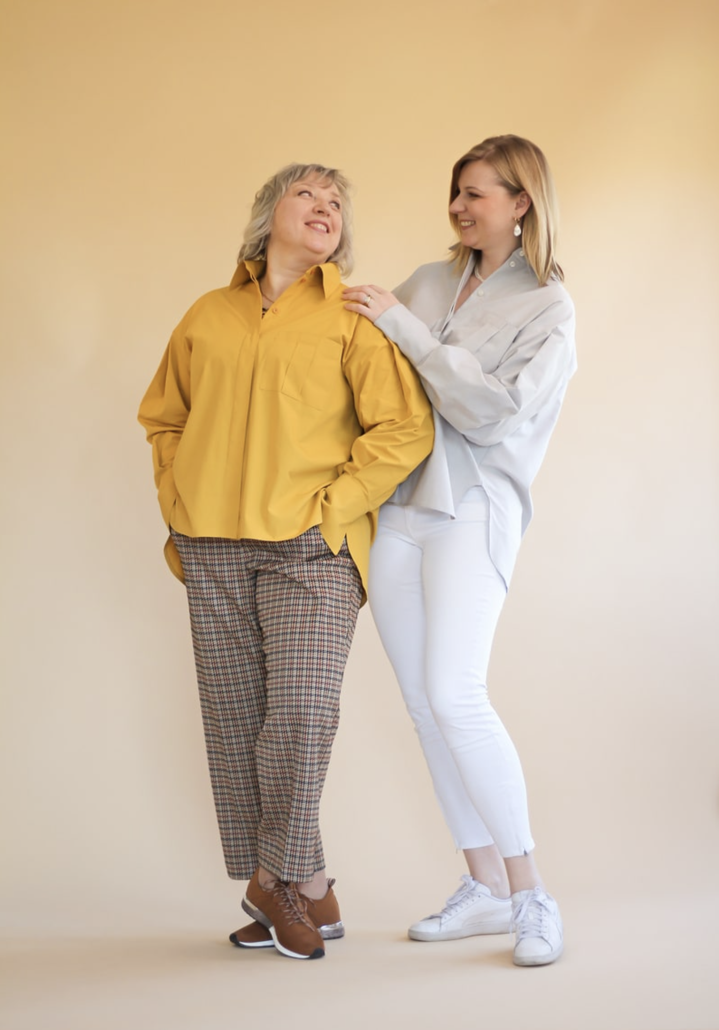 Women wearing the Misha Shirt sewing pattern by Lenaline Patterns. An oversized shirt pattern made in cotton’s, linen, tencel, chino or flannel fabrics, featuring long sleeves, with pleats at the top and bottom, ending in wide cuffs, shirt collar, hidden 