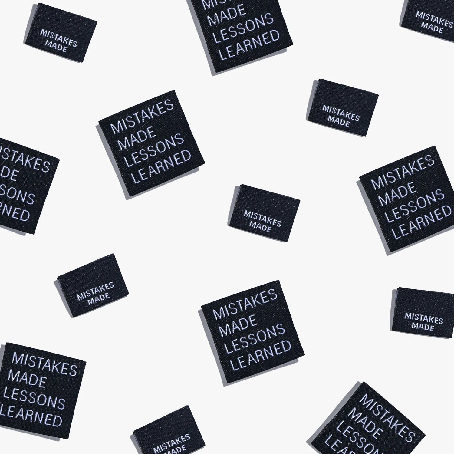 Photo showing 'Mistakes Made Lessons Learned' Cotton Labels from Kylie & The Machine on The Fold Line. A washable, durable, and non-scratchy cotton label featuring black coloured backgrounds with white text, they are all ready to be sewn into your handmad
