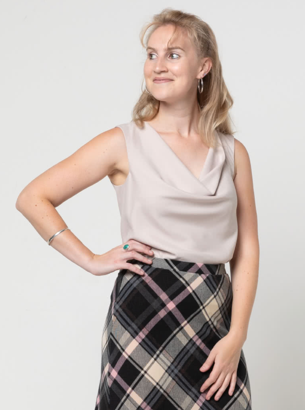 Woman wearing the Monroe Woven Top sewing pattern from Style Arc on The Fold Line. A top pattern made in silk, rayon, or any soft fabrics, featuring a cowl neck, sleeveless, bias cut, lined, and sits on the high hip.