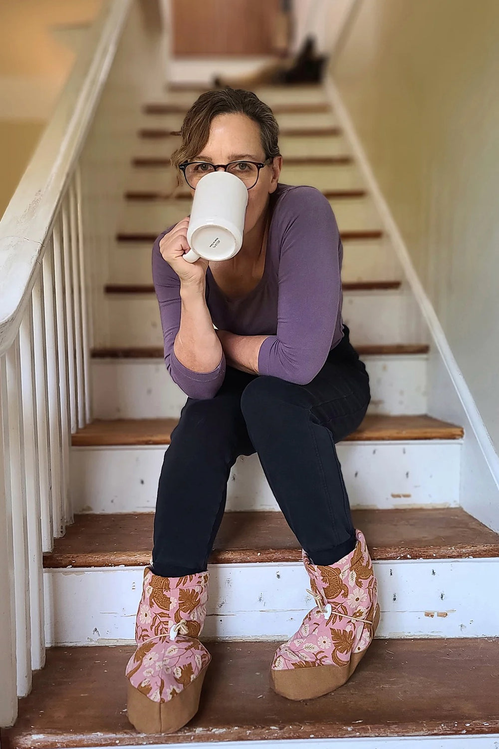 Woman wearing the Moon Booties sewing pattern from Sew House Seven on The Fold Line. A booties pattern made in technical, synthetic, and outdoor fabrics, featuring a slip-on style, lined, inner ankle elastics, foot bridge, outer ankle adjustable cord and 