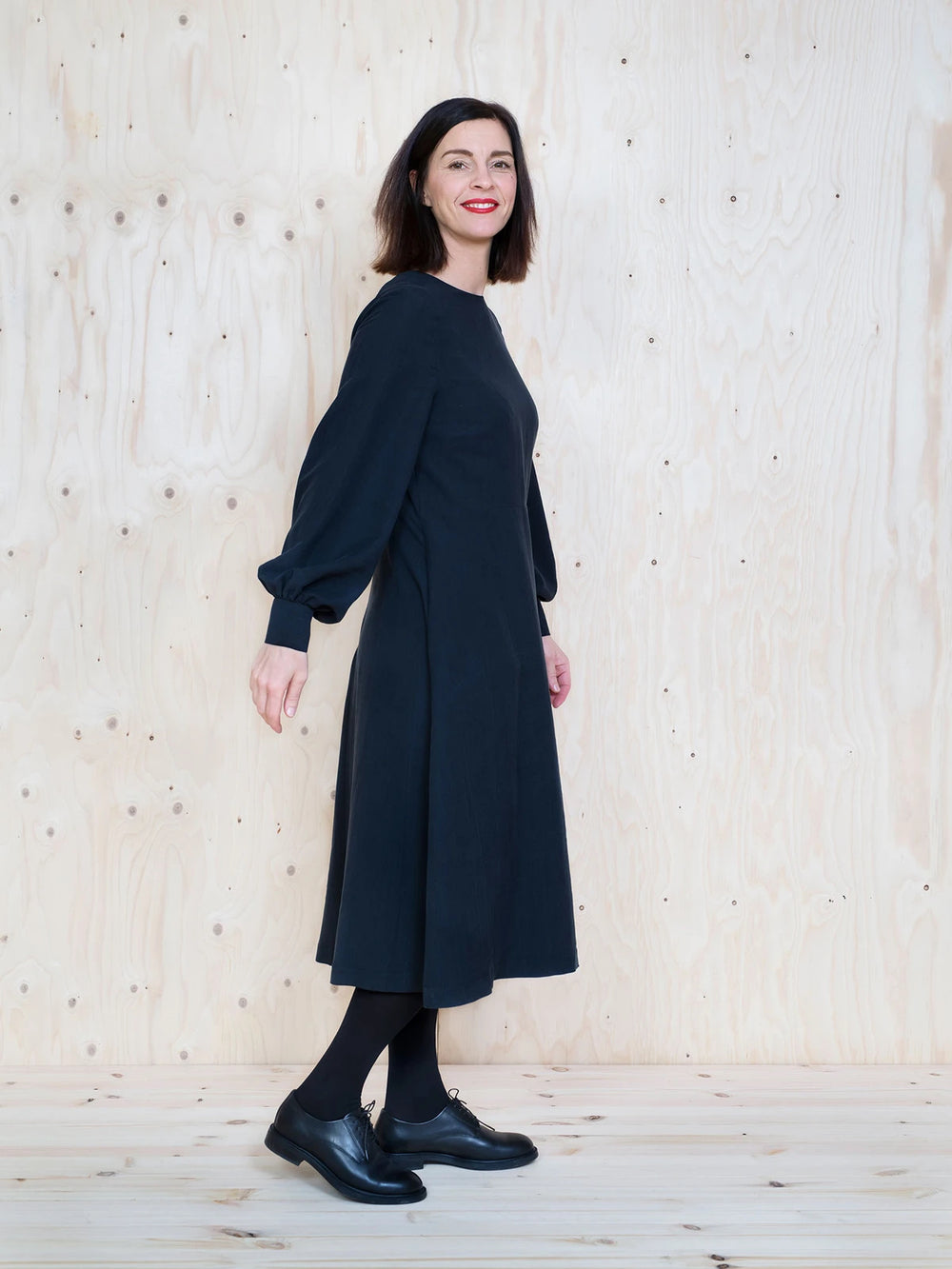 Woman wearing the Multi-Sleeve Midi Dress sewing pattern by The Assembly Line. A dress pattern made in light to medium weight fabrics such as, cotton, tencel, silk, linen, crepe de chine or wool crepe fabrics, featuring an A-line silhouette, round neck, c