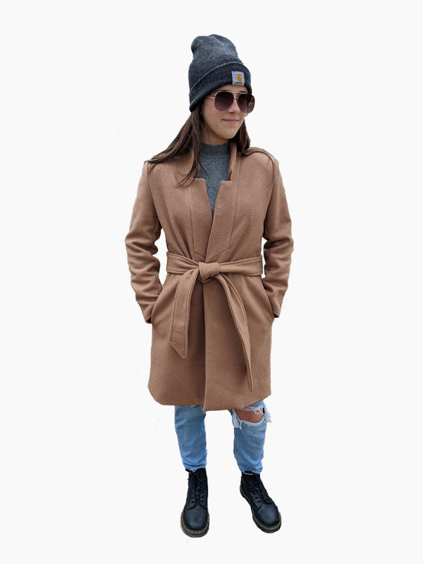 Woman wearing the Narva Coat sewing pattern from Hey June Handmade on The Fold Line. A coat pattern made in wool, bouclé, tweed, or wool blend fabrics, featuring a relaxed fit, in-seam pockets, decorative lapel notch, stand collar, knee length and self-fa
