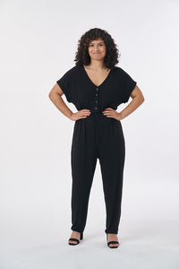 Woman wearing the Nasima Jumpsuit sewing pattern from Sew Over It on The Fold Line. A jumpsuit pattern made in cotton jersey, bamboo, viscose, cotton/elastane or cotton/polyester/spandex jersey blends fabrics, featuring grown on sleeves with short cuffs, 