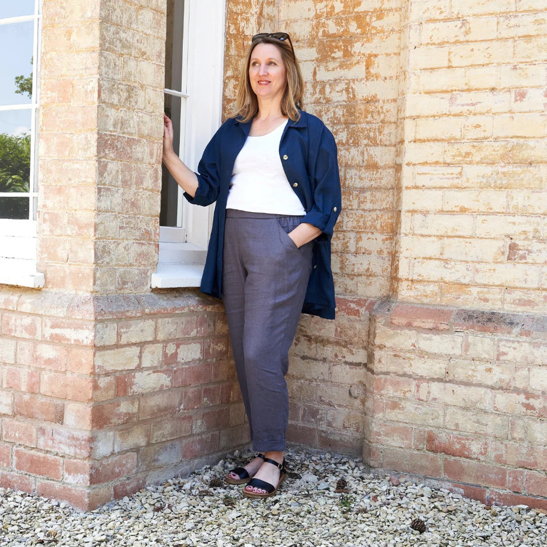 Woman wearing the Nell Trouser sewing pattern from Sew Me Something on The Fold Line. A trouser pattern made in linen, chambray, ramie, viscose rayon, denim, corduroy, or cotton drill fabrics, featuring a relaxed fit, pull-on style, slim leg, flat front w