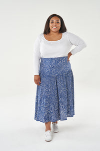 Woman wearing the Niamh Skirt sewing pattern from Sew Over It on The Fold Line. A skirt pattern made in rayon/viscose, crepe or Tencel lawn fabrics, featuring a V-shaped yoke, close-fitting around the waist and hips, full gathered skirt, midi length finis