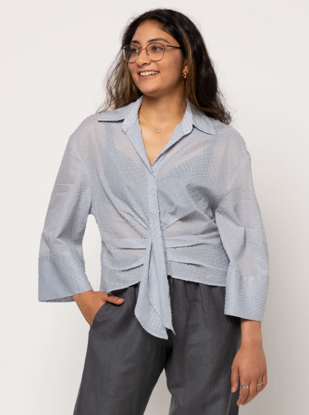 Woman wearing the Nicola Woven Shirt sewing pattern from Style Arc on The Fold Line. A shirt pattern made in, rayon, silk or cotton fabrics, featuring a button-front, faux tie, lower front tucks, double yoke, two-piece collar, slightly dropped shoulders a