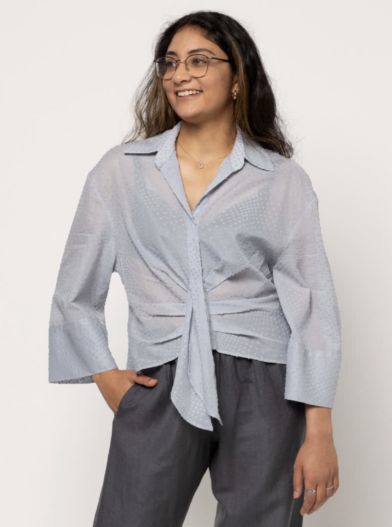 Woman wearing the Nicola Woven Shirt sewing pattern from Style Arc on The Fold Line. A shirt pattern made in, rayon, silk or cotton fabrics, featuring a button-front, faux tie, lower front tucks, double yoke, two-piece collar, slightly dropped shoulders a