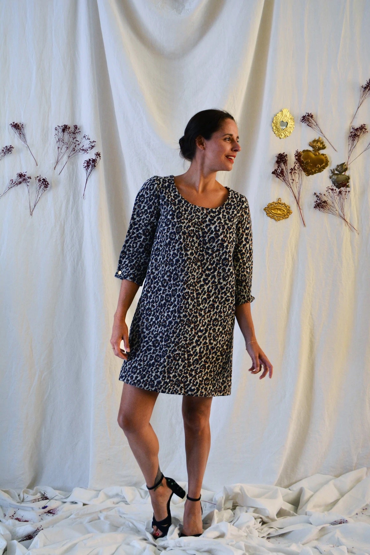 Woman wearing the Niki Dress sewing pattern from Maison Fauve on The Fold Line. A dress pattern made in Jacquard, light wool, crepe, tencel, crepe, viscose, cotton, linen or silk fabrics, featuring a trapeze silhouette, above knee length, ¾ length sleeves