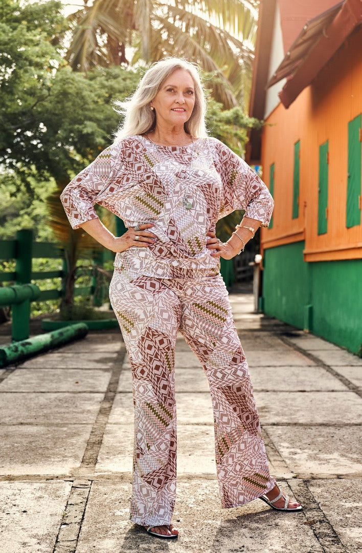 Woman wearing the Nilma Palazzo Pants sewing pattern from Sirena Patterns on The Fold Line. A trouser pattern made in nylon spandex, poly spandex, cotton spandex or two-way stretch fabrics, featuring a high waist, wide waistbands and flared leg from the k