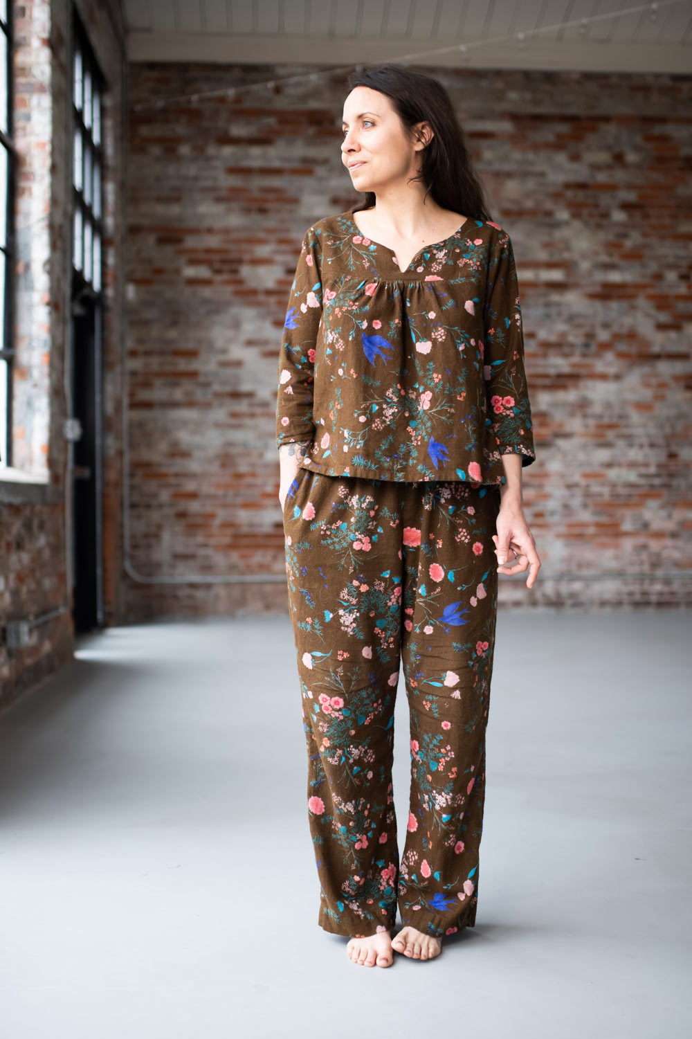 Woman wearing the Nocturne Pajamas sewing pattern from Sew Liberated on The Fold Line. A PJ pattern made in cottons, linens, hemp, flannel, rayon or silk charmeuse fabrics, featuring front and back yokes with gathers, V-notch at the neckline, slight high-