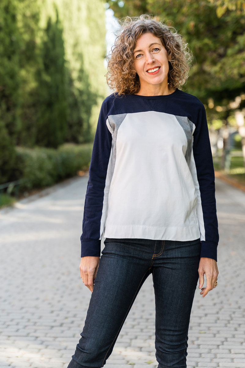 Woman wearing the Noord T-shirt sewing pattern from Liesl + Co on The Fold Line. A Tee pattern made in cotton jersey, interlock, french terry, and cotton fleece fabrics, featuring a colour-blocked design, boxy fit, shirt-tail hem, round neck, and long sle
