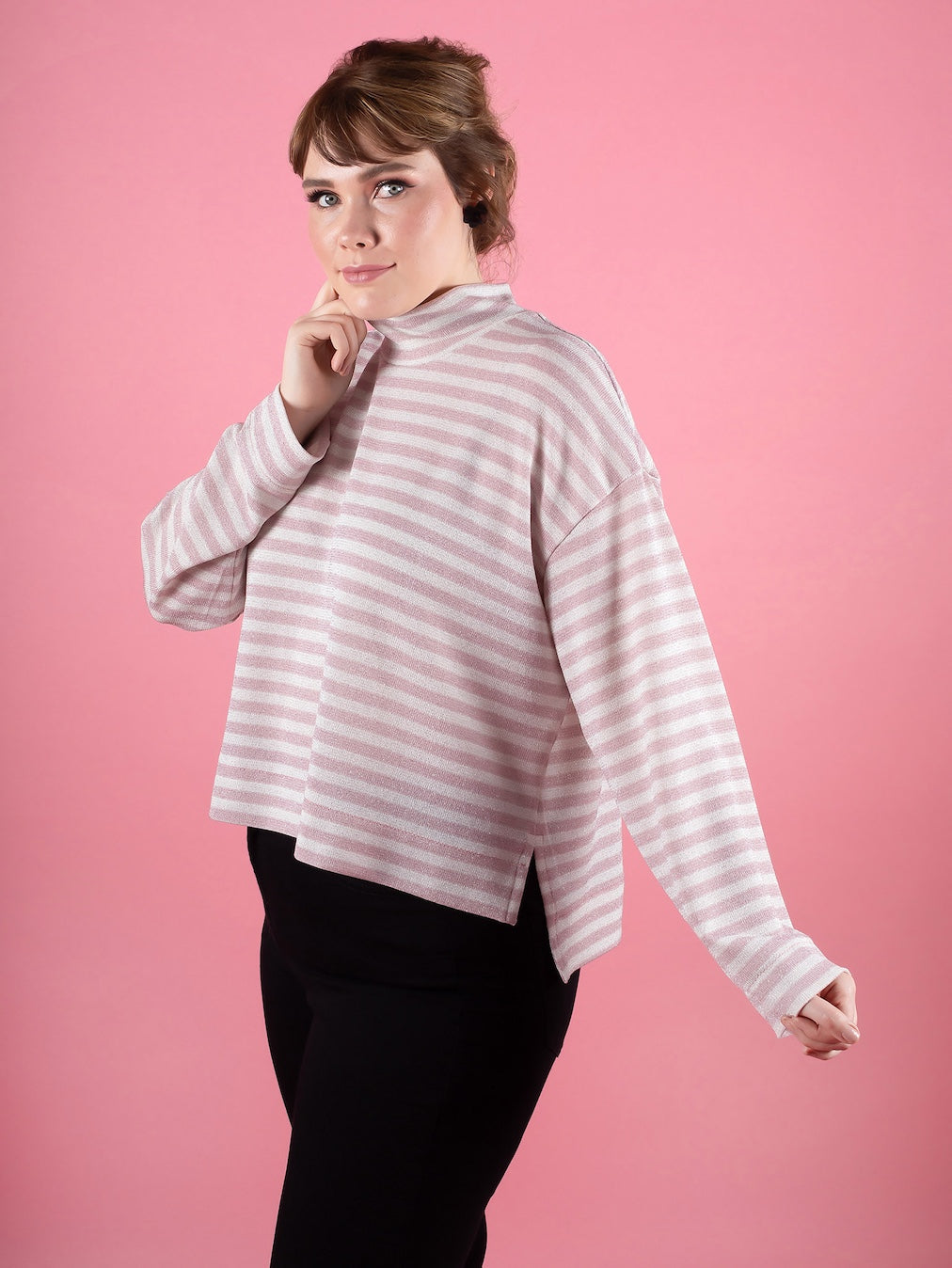 Woman wearing the Nora Top sewing pattern from Tilly and the Buttons on The Fold Line. A sweater or tee pattern made in jersey, interlock, ponte, sweater knit, or stretch velvet fabric, featuring a slouchy high neck, cropped and stepped deep hem with side
