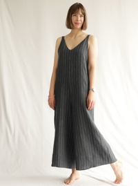 Woman wearing the Norman Jumpsuit sewing pattern from Style Arc on The Fold Line. A jumpsuit pattern made in washed linen, cotton or crepe fabrics, featuring a pull-on style, front and back deep V-neck, set-in shoulder straps, deep armholes, wide 7/8-leng