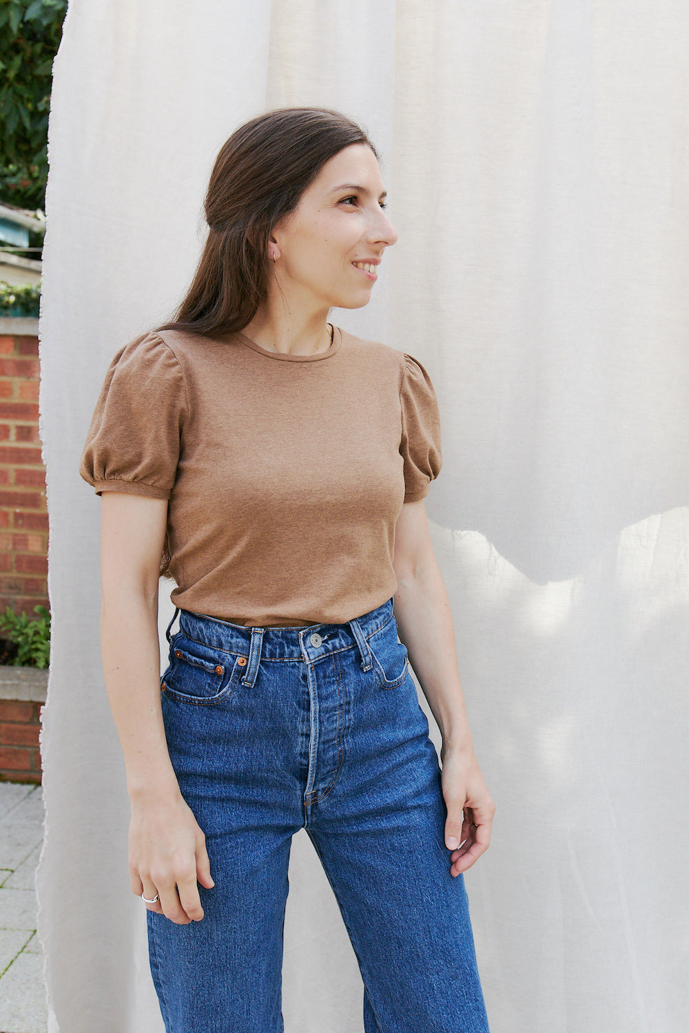 Woman wearing the Nuage Balloon Sleeve Shirt sewing pattern from Camimade on The Fold Line. A T-shirt top pattern made in cotton jersey fabrics, featuring short balloon sleeves, round neck and semi-fit.