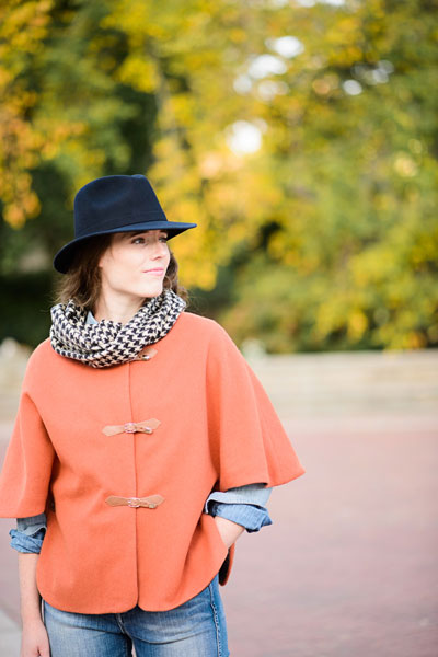 Woman wearing the Woodland Stroll Cape sewing pattern from Liesl + Co on The Fold Line. A cape pattern made in wool coating, wool melton, velveteen (cotton velvet), moleskin, or corduroy fabrics, featuring a full lining, round neck, elbow length sleeves, 