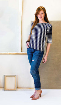 Woman wearing the Maritime Knit Top sewing pattern from Liesl + Co on The Fold Line. A knit top pattern made in jersey, double knit, thermal knit, and interlock fabrics, featuring a pull-on style, three-quarter-length sleeves, bateau neck with topstitchin