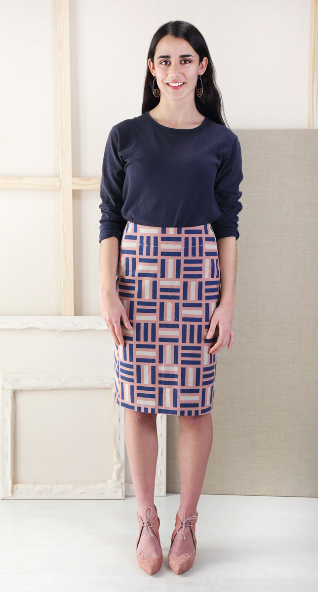 Woman wearing the Extra-sharp Pencil Skirt sewing pattern from Liesl + Co on The Fold Line. A pencil skirt pattern made in twill, canvas, linen, denim, wool suiting, and faux leather fabrics, featuring side panels, back yoke, back walking vent, knee lengt