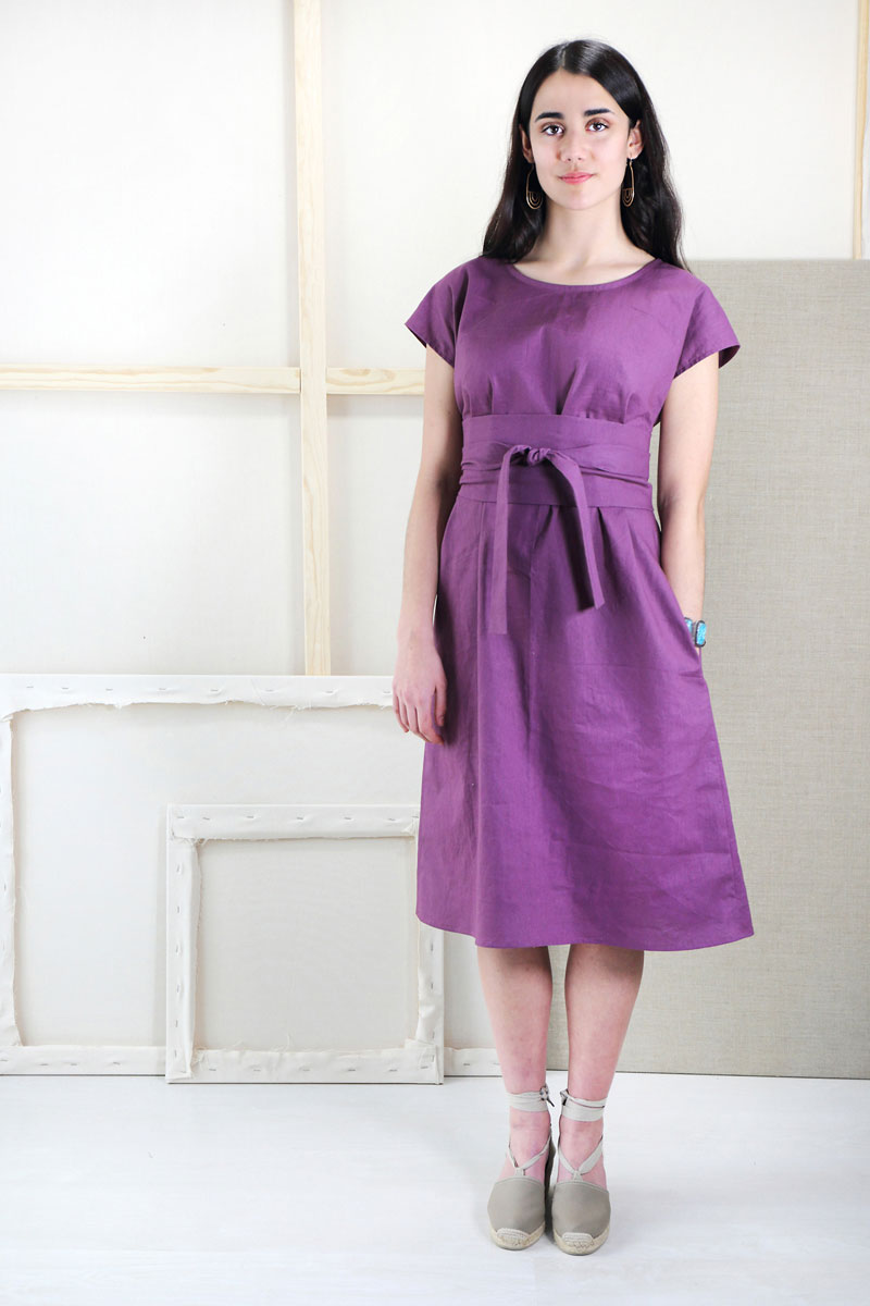 Woman wearing the Terrace Dress sewing pattern from Liesl + Co on The Fold Line. A dress pattern made in linen, double gauze, rayon, shirting, and quilting cotton fabrics, featuring a loose fit, bust darts, in-seam pockets, scoop neck, short sleeves, belo