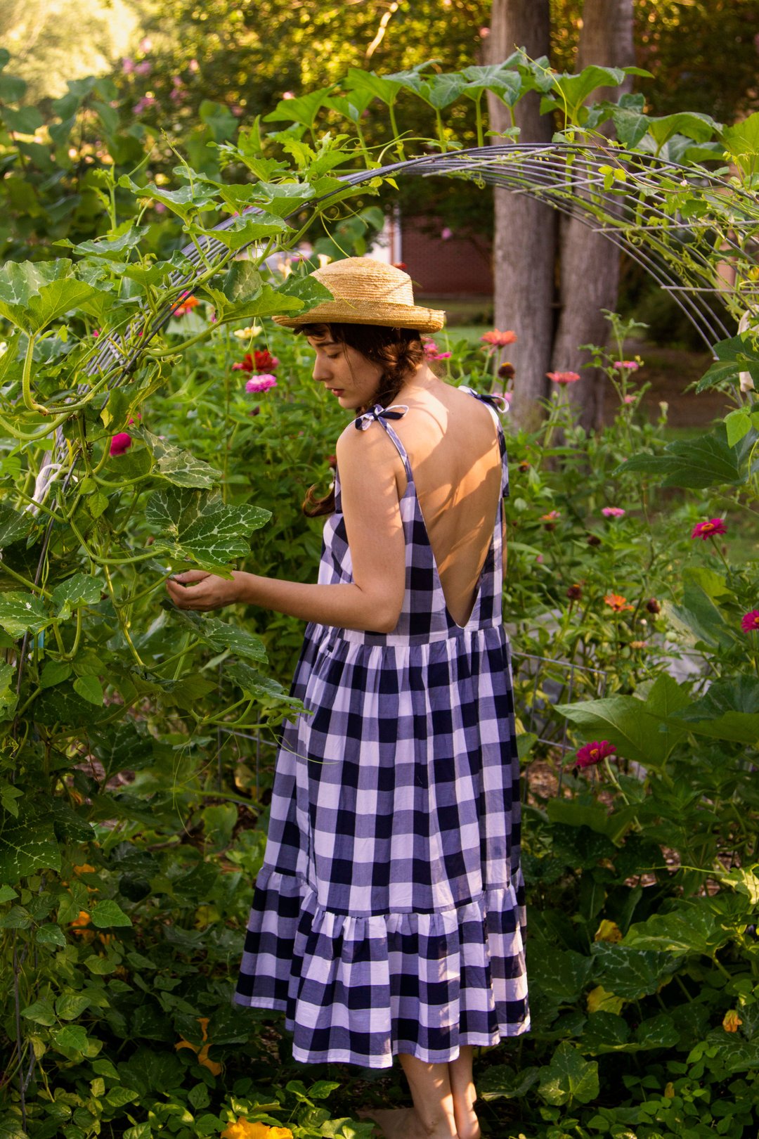 Woman wearing the Olive Dress pattern from Untitled Thoughts on The Fold Line. A sleeveless dress pattern made in tropical weight wool, wool suiting, silk noil, silk charmeuse, flannel, linen, double gauze, cotton voile or chambray fabrics, featuring a te