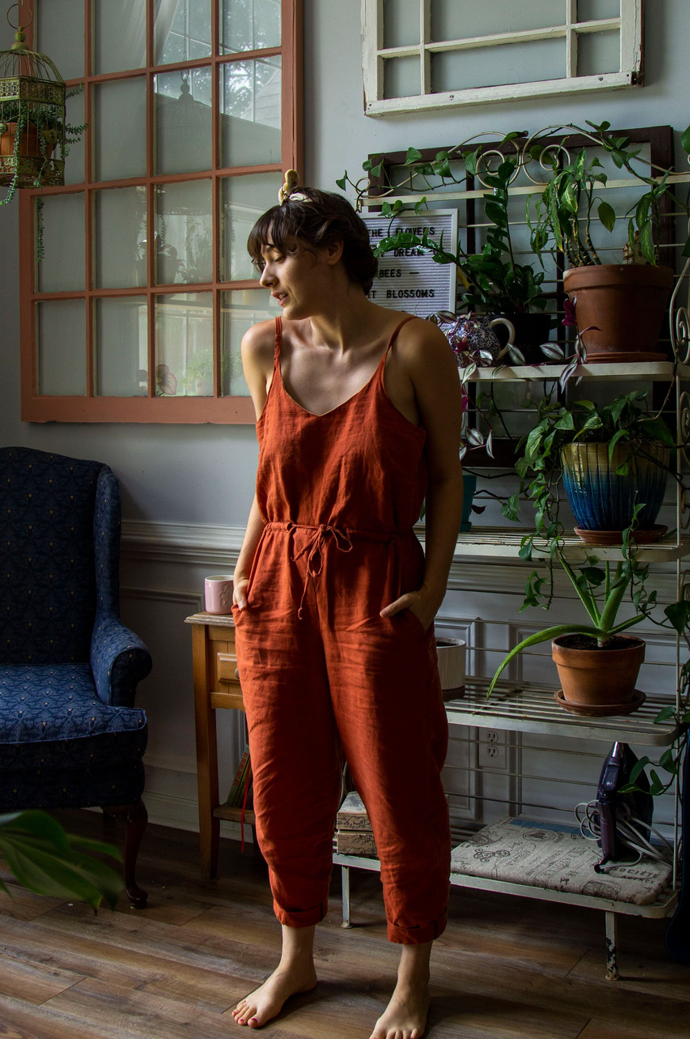 Woman wearing the Olive Jumpsuit pattern from Untitled Thoughts on The Fold Line. A jumpsuit pattern made in tropical weight wool, wool suiting, silk, flannel, linen, chambray, cotton poplin, rayon challis or rayon/linen blend fabrics, featuring a deep V 