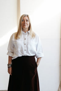 Woman wearing the Olya Shirt pattern from Paper Theory Patterns on The Fold Line. An Oxford shirt pattern made in cotton, linen, flannel, crepe de chine, viscose, georgette, corduroy or denim fabrics, featuring a relaxed fit, collar and stand, front butto
