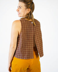 Woman wearing the Open Back Smock Top sewing pattern from Matchy Matchy on The Fold Line. A top pattern made in light to medium weight woven fabrics, featuring an open back, single back button neck closure, sleeveless, round neckline, A-line silhouette, s