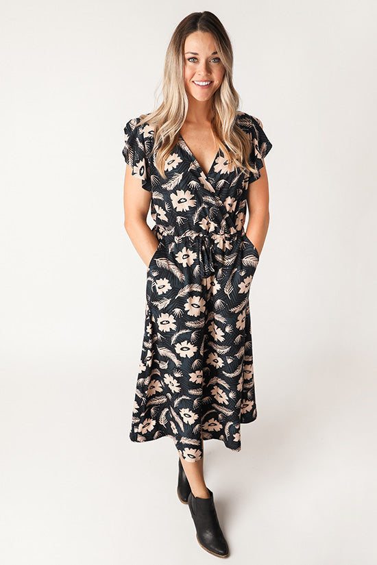 Woman wearing the Orchid Midi Dress sewing pattern from Chalk and Notch on The Fold Line. A wrap dress pattern made in rayon challis, rayon crepe, rayon voile, cotton lawn, cotton voile, linen or double gauze fabrics, featuring ruffle sleeves, an elastic 