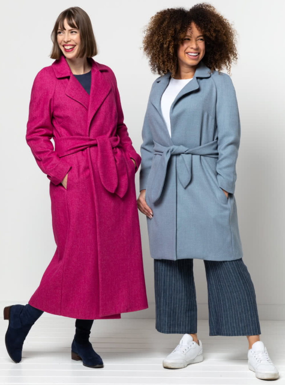 Women wearing the Ormond Designer Coat sewing pattern from Style Arc on The Fold Line. A wrap coat pattern made in wool cashmere, wool melton or gabardine fabrics, featuring waist ties, raglan sleeves, two-piece collar, angled pleats on back bodice, wide 