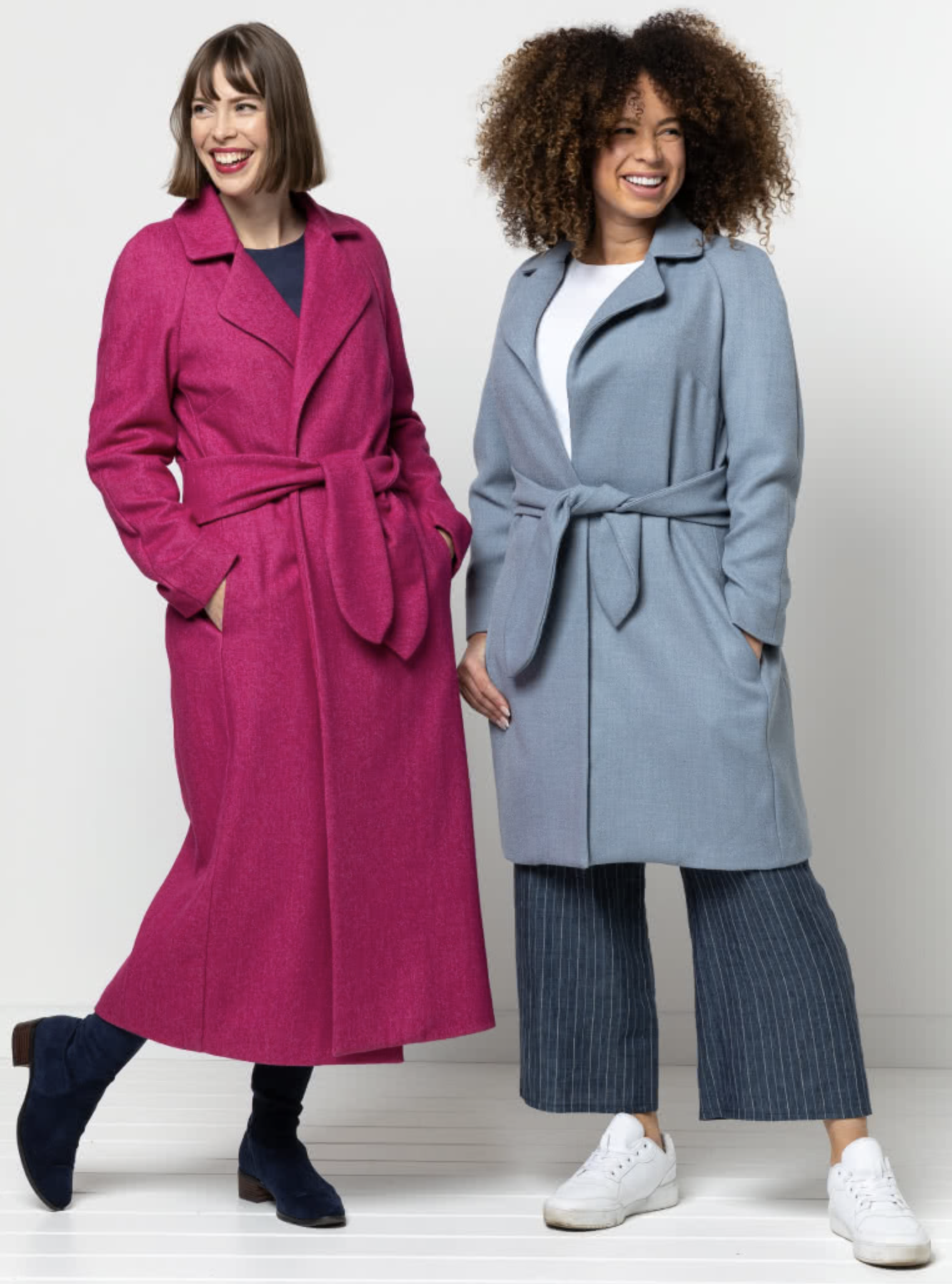 Women wearing the Ormond Designer Coat sewing pattern from Style Arc on The Fold Line. A wrap coat pattern made in wool cashmere, wool melton or gabardine fabrics, featuring waist ties, raglan sleeves, two-piece collar, angled pleats on back bodice, wide 