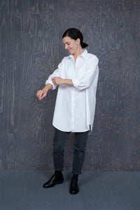 Woman wearing the Oversized Shirt sewing pattern by The assembly Line. A shirt pattern made in cotton, linen, lawn or silk fabric featuring a classic style with an oversized fit, side seam pockets, front button closure, rear box pleat and traditional shir