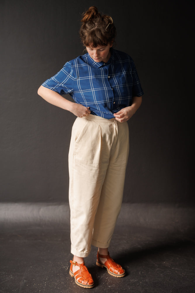 Woman wearing the Pegs Trousers sewing pattern from Merchant & Mills on The Fold Line. A trousers pattern made in mid-heavyweight cotton canvas, 8 oz. organic sanded twill, corduroy, light-medium weight woollens, or 7-10 oz. denim fabric, featuring a tape